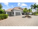 Beautiful exterior shot with large driveway, lush landscaping, and a three-car garage at 9138 Great Heron Cir, Orlando, FL 32836