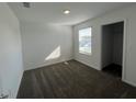 This bedroom boasts wall-to-wall carpeting and a bright window, ready for your personal touches at 930 Cattleman St, Winter Haven, FL 33881