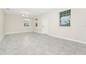 Bright, empty living room featuring neutral paint, recessed lighting, and tile flooring at 9909 Alliteration Aly, Winter Garden, FL 34787