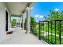 Spacious porch with views of the manicured lawn and neighborhood at 9909 Alliteration Aly, Winter Garden, FL 34787