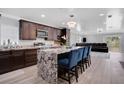 Modern kitchen featuring granite counters, stainless steel appliances, and breakfast bar seating at 1167 Lake Blanche Dr, Orlando, FL 32808