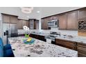 Modern kitchen featuring granite counters, stainless steel appliances, and dark wood cabinetry at 1167 Lake Blanche Dr, Orlando, FL 32808