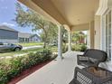 Inviting covered front porch featuring comfortable seating, providing a relaxing outdoor space at 14044 Chicora Crossing Blvd, Orlando, FL 32828