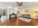 Inviting living room with hardwood floors, ceiling fan, and abundant natural light at 14213 Turning Leaf Dr, Orlando, FL 32828