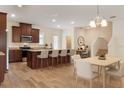Modern kitchen with stainless steel appliances, granite countertops, and breakfast bar seating at 15477 Blackbead St, Winter Garden, FL 34787
