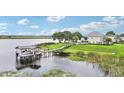 Gorgeous waterfront property featuring a private dock and meticulously maintained grounds at 15779 Tangerine Dream Ct, Winter Garden, FL 34787