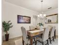 Formal dining room featuring a chandelier, neutral paint, and a decorative mirror at 1613 Water Elm Ct, Orlando, FL 32825