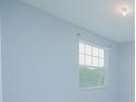 Cozy bedroom with light-blue walls and a bright window at 171 Seville Dr, Davenport, FL 33837