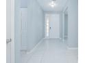 Bright foyer with tiled floors, light-blue walls, and a decorative chandelier at 171 Seville Dr, Davenport, FL 33837