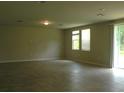 Spacious living room with tile floors, recessed lighting, and sliding door to the backyard at 17305 Cagan Crossings Blvd, Clermont, FL 34714