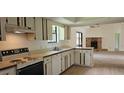 Classic kitchen with vintage cabinets and stove, open to the living area at 2008 Juniper Dr, Edgewater, FL 32141