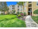 Exterior shot of condo building with lush landscaping and inviting walkway at 2821 Almaton Loop # 105, Kissimmee, FL 34747