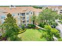 Beautiful condo building with lush landscaping and large green spaces at 2821 Almaton Loop # 105, Kissimmee, FL 34747