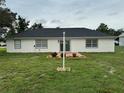 Rear view of the house showcasing a well-maintained backyard with a small patio area perfect for outdoor enjoyment at 2864 Trenton Ln, Deltona, FL 32738