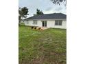 Features an expansive, well-maintained backyard with lush grass and garden area with an outdoor patio at 2864 Trenton Ln, Deltona, FL 32738