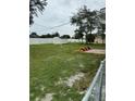 A sprawling backyard includes green grass, a garden area and a storage shed, all enclosed by a white fence at 2864 Trenton Ln, Deltona, FL 32738