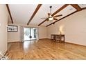 Bright living room with wood floors, exposed beams, ceiling fan, and sliding glass doors leading to the outdoors at 353 Wekiva Cove Rd, Longwood, FL 32779
