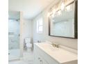 Bright bathroom featuring a sleek vanity, modern lighting, and walk-in shower at 3823 Avenue R Nw, Winter Haven, FL 33881