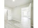 Bright bedroom featuring open door and gray flooring at 3823 Avenue R Nw, Winter Haven, FL 33881