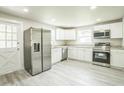 Updated kitchen with stainless steel appliances, granite countertops, and white cabinetry at 3823 Avenue R Nw, Winter Haven, FL 33881