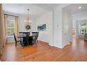 Elegant dining room featuring hardwood floors, crown molding and a decorative chandelier at 4065 Anissa Ave, Orlando, FL 32814