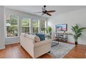 Bright living room featuring a comfortable sofa, a ceiling fan and a large window view at 4065 Anissa Ave, Orlando, FL 32814