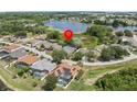 Neighborhood aerial view of the houses and a large lake. The property's location is marked with a red pin at 407 Grand Reserve Dr, Davenport, FL 33837