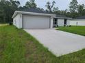 Charming single-story home featuring a two-car garage and a long driveway at 4333 Sw 157Th Ter, Ocala, FL 34481