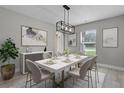 Modern dining room features artwork, stylish decor, and a window with a view of the outdoors at 4519 Willamette Cir, Orlando, FL 32826