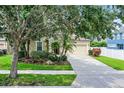 Charming single-Gathering home featuring a well-manicured lawn, two-car garage, and inviting front porch at 5063 Carillon Ln, Windermere, FL 34786