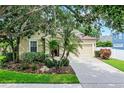 Charming home exterior featuring a well-manicured lawn and two-car garage at 5063 Carillon Ln, Windermere, FL 34786