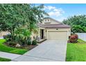Charming single-Gathering home featuring a well-manicured lawn, two-car garage, and inviting front porch at 5063 Carillon Ln, Windermere, FL 34786