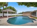 Private backyard oasis with a sparkling blue pool and a covered patio, perfect for entertaining at 5089 Jennifer Pl, Orlando, FL 32807