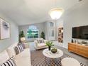 Bright living room with large windows offering scenic views, complemented by modern furnishings at 5231 Alavista Dr, Orlando, FL 32837