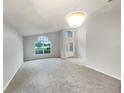 Spacious living room with carpeted floors and large windows offering great natural light at 5231 Alavista Dr, Orlando, FL 32837