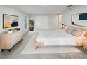 Well-lit main bedroom featuring neutral tones, a large closet, and stylish contemporary decor at 5231 Alavista Dr, Orlando, FL 32837