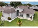 Aerial view of a well-maintained single-story home with manicured lawn and white rock beds at 5517 W Sacramento Ct, Orlando, FL 32821