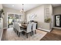 Elegant dining room with a large table, seating for ten, and stylish decor at 610 Strihal Loop, Oakland, FL 34787