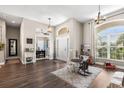 Spacious living room with beautiful hardwood floors and ample natural light at 610 Strihal Loop, Oakland, FL 34787