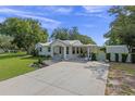 Charming home with a covered side patio, well maintained lawn and mature shade trees at 63 Madera Rd, Debary, FL 32713