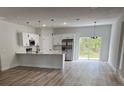 Modern kitchen featuring an island, stainless steel appliances, and pendant lighting over the countertop at 706 Marion Oaks Manor, Ocala, FL 34473