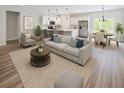 Open-concept living room, kitchen and dining area features modern furnishings and plenty of natural light at 706 Marion Oaks Manor, Ocala, FL 34473