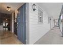 Inviting condo entryway featuring stylish light fixtures and an open door to the interior at 720 Celebration Ave # 245, Kissimmee, FL 34747
