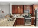 Well-equipped kitchen featuring granite countertops, stainless steel appliances, and abundant cabinet space at 720 Celebration Ave # 245, Kissimmee, FL 34747