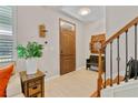 Inviting foyer with tiled floors, wooden front door, staircase, and decorative accents for a warm welcome at 888 Wakulla Ln, Winter Springs, FL 32708