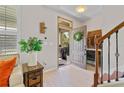 Open foyer showcasing front door, staircase, and decorative touches, creating a welcoming entrance at 888 Wakulla Ln, Winter Springs, FL 32708