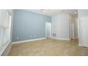 Spacious living room featuring tile floors, cool toned walls, a ceiling fan, and natural light at 1061 Citrus Landings Blvd, Davenport, FL 33837