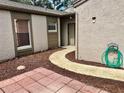 Inviting entryway with a charming garden hose and a tiled pathway at 1110 Woodbine Street, Fern Park, FL 32730
