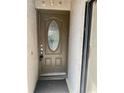 Close-up of a brown front door with an oval decorative glass insert at 1110 Woodbine Street, Fern Park, FL 32730