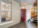 Welcoming entryway with a red door, natural light and stylish decor elements at 1200 Ironsmith Dr # 508, Celebration, FL 34747